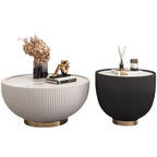 Two round side tables, one white and one black, with decorative items on a white background.
