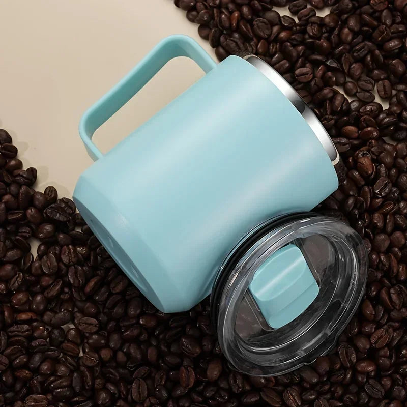 Light blue mug with a clear lid on coffee beans