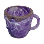 Colorful purple resin coffee mug with a textured brown rim and a comfortable handle, showcasing a mineral crystal design.