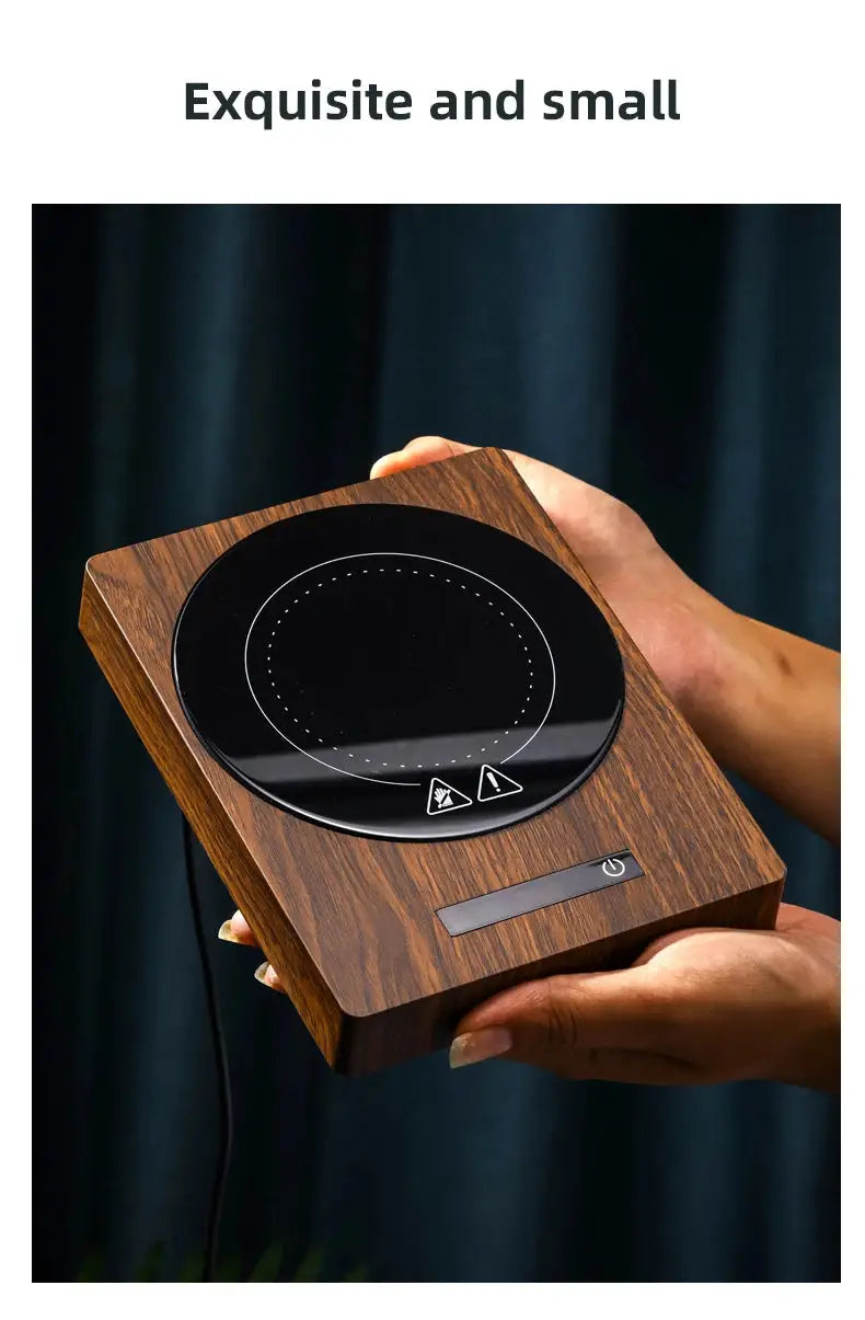 100°C Cup Heater Mug Warmer with automatic power-off, shown warming tea in a glass teapot on a wooden heating pad, ideal for hot beverages.