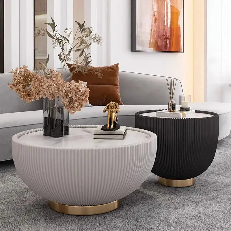 Modern living room with a white coffee table, black side table, and decorative items.