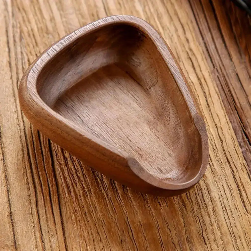 Wooden foot-shaped dish on a wooden surface