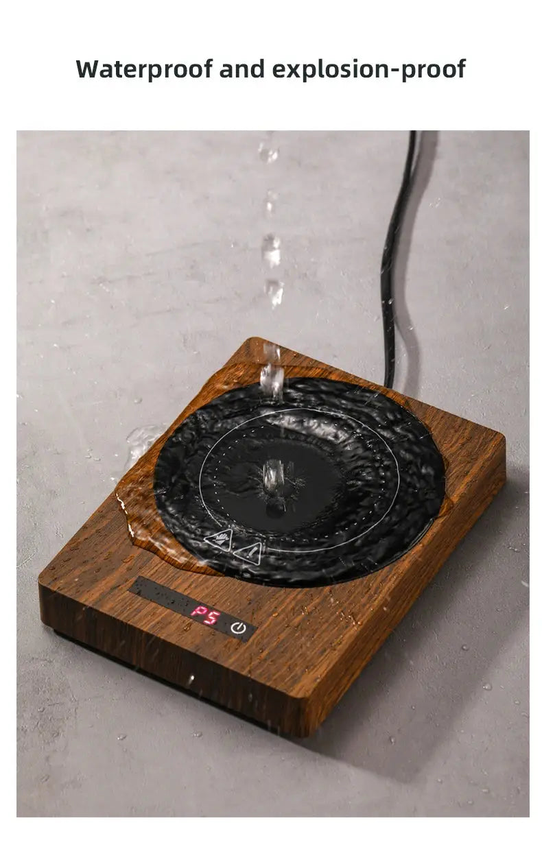 100°C Cup Heater Mug Warmer with automatic power-off, shown warming tea in a glass teapot on a wooden heating pad, ideal for hot beverages.