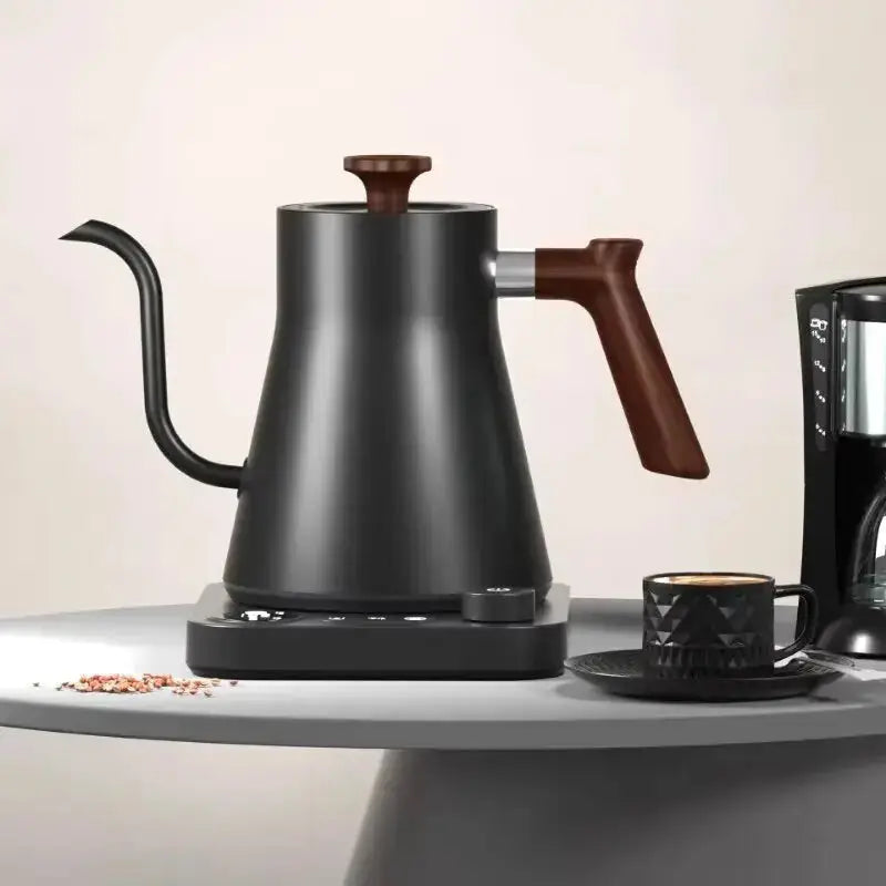 Portable gooseneck electric kettle with thermal insulation, ideal for travel. Features a sleek black stainless steel design with precise temperature control.