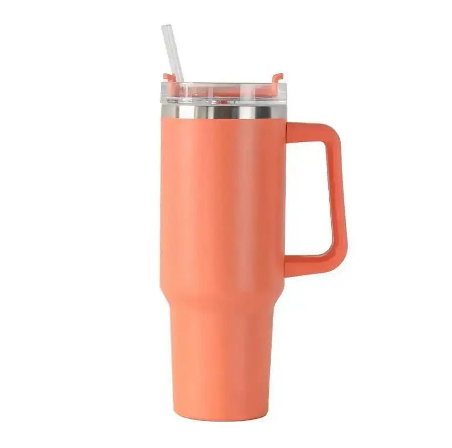 Coral mug with handle and straw on a white background