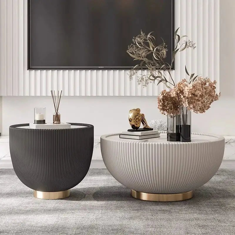 Two modern side tables with decorative items in a living room setting.