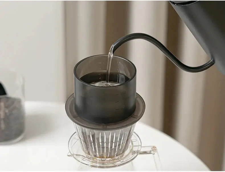 Pouring water into the TIMEMORE SimpleDrip Water Dropper, designed for controlled and precise pour-over coffee brewing.