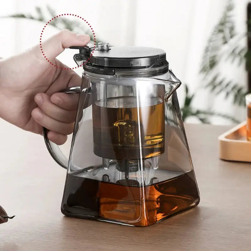Elegant glass teapot with press tea strainer, featuring a heat-resistant design and water separation filter. Ideal for brewing loose-leaf, herbal, and flower teas.