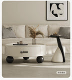 Modern living room with a white sofa, round coffee table, and decorative items.