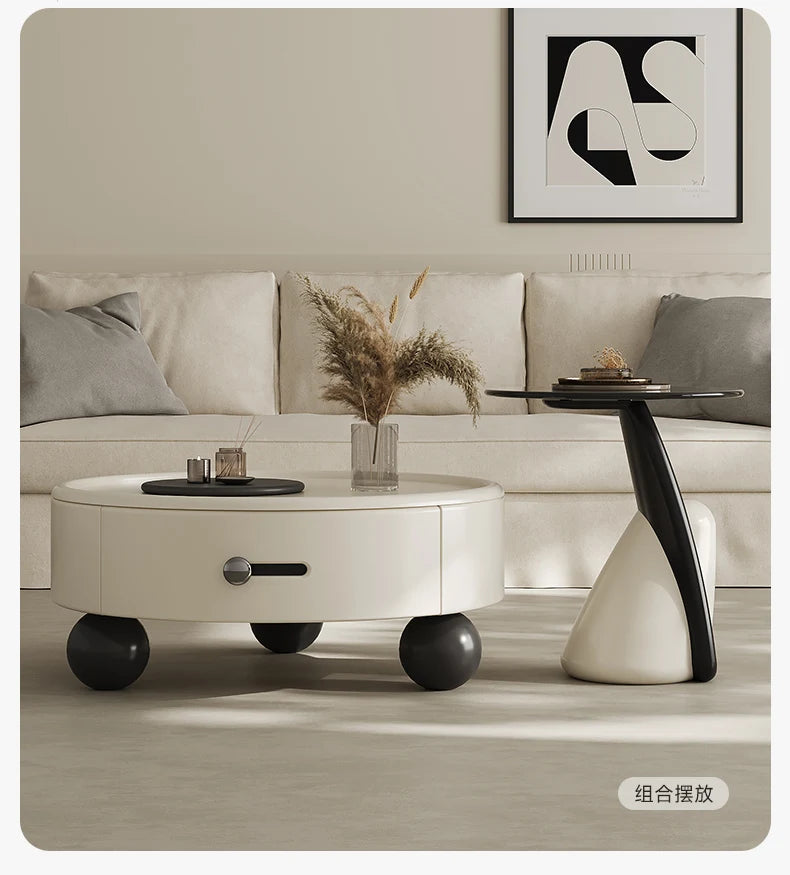 Modern living room with a white sofa, round coffee table, and decorative items.