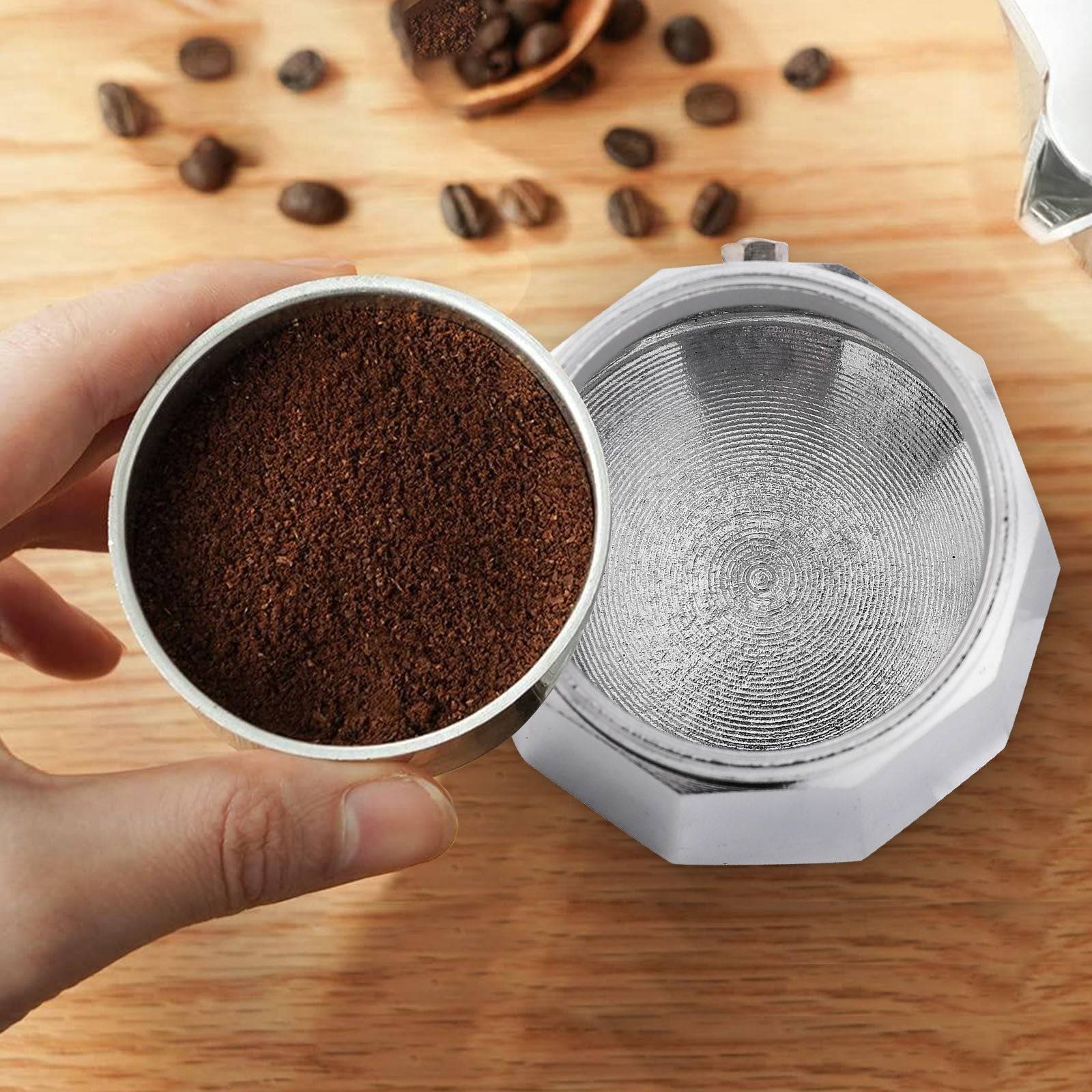 RAINBEAN Stovetop Espresso Maker brewing rich coffee into a white cup. Classic Italian Moka pot design with durable aluminum body for 3 cups.