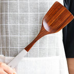 Japanese-style teak kitchen utensil with a lacquer finish, featuring a wide vegetable shovel design. Eco-friendly, durable, and safe for non-stick cookware.
