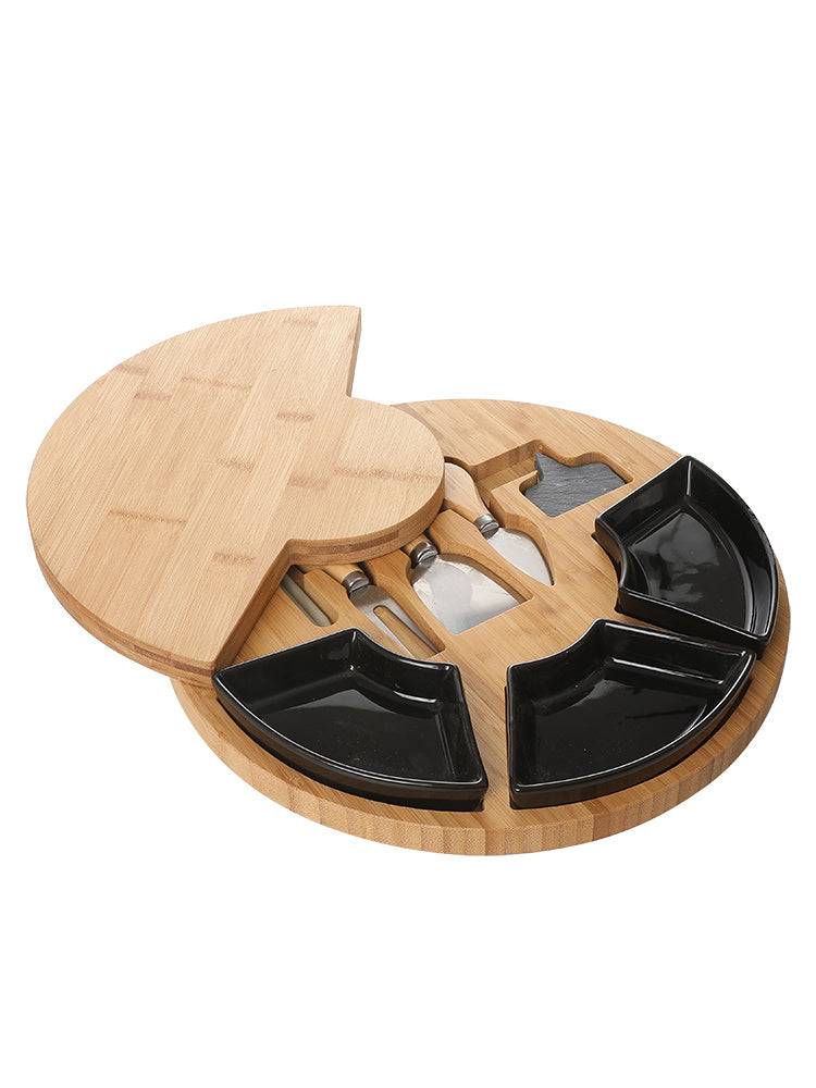 Wooden cutting board with divided sections and utensils on a white background