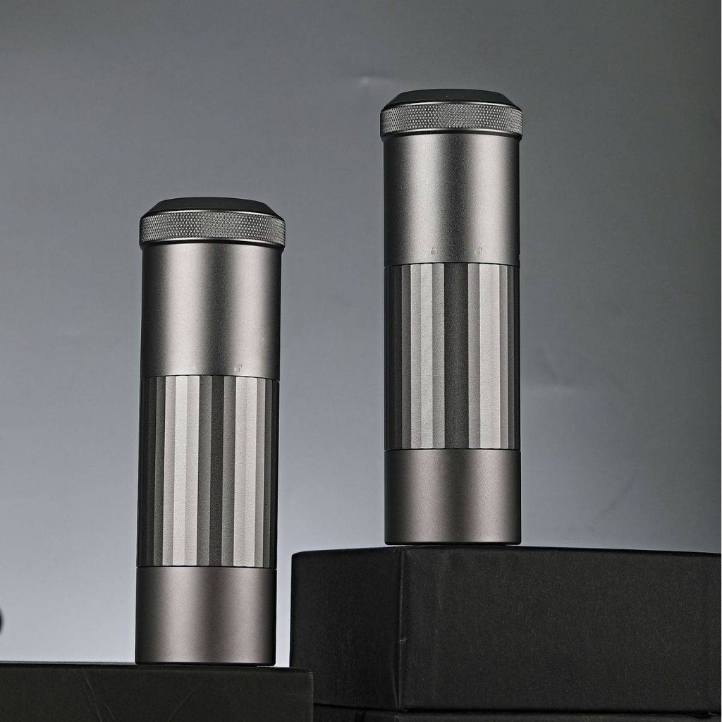 Two Portable Wireless Bean Grinders displayed on black platforms. Minimalist design with USB charging for efficient coffee grinding.