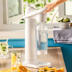 Manual home soda dispenser sparkling machine in white, made of ABS plastic. Ideal for creating refreshing carbonated drinks with included bottle.