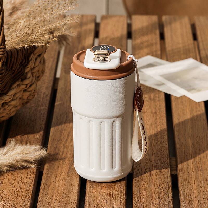 White smart digital thermal bottle with brown lid and temperature display, 450ml. Stylish and functional insulated coffee mug for daily use.